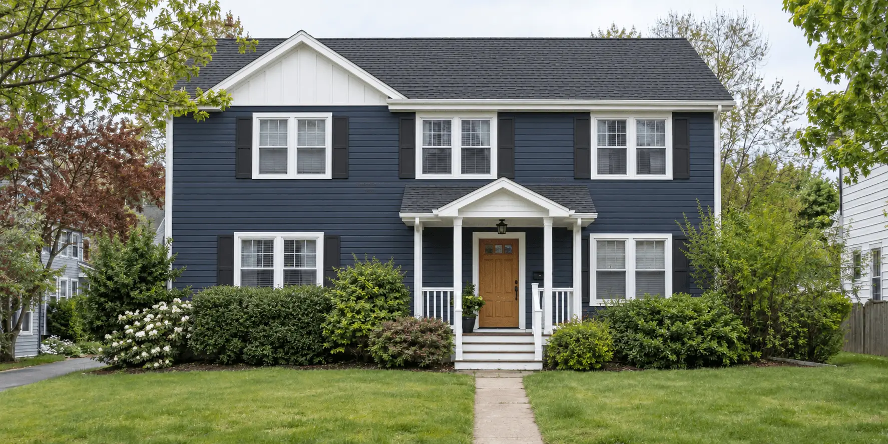 AI-generated demo: the same house with navy siding, a new charcoal roof, refreshed white trim and an oak front door after renovation